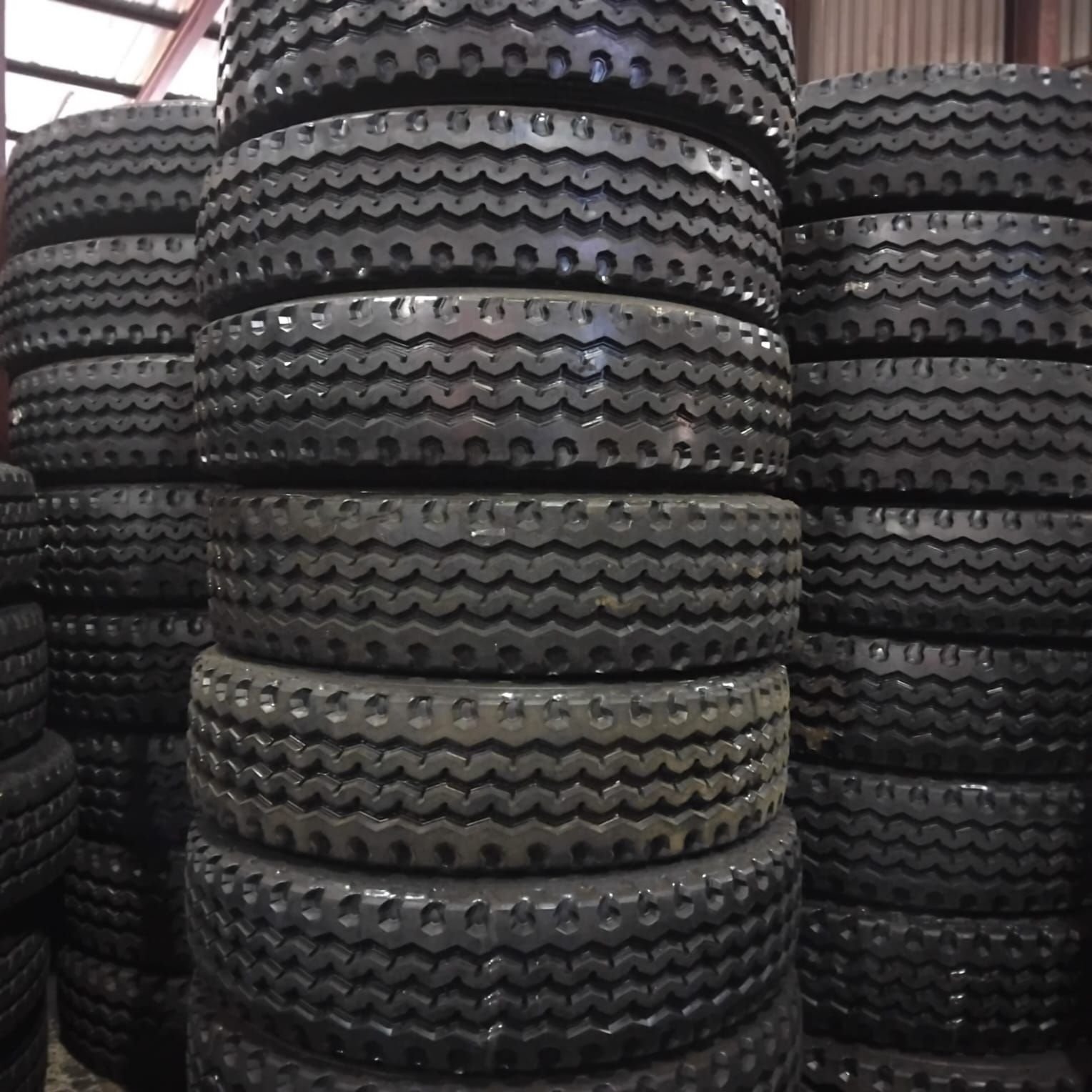 Stacks of 315/80R22.5 M103 stock retreads in the 3G Tyres warehouse